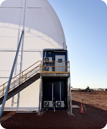A prominent white building with entrance stairs, where Progrid provides specialised Electrical and HVAC services supporting critical mining infrastructure