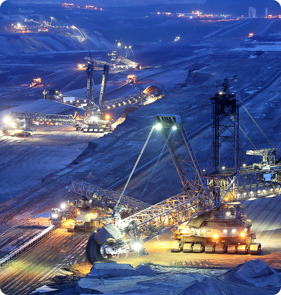 A large crane operates in a mine, used by electrical maintenance mining contractors for heavy lifting tasks