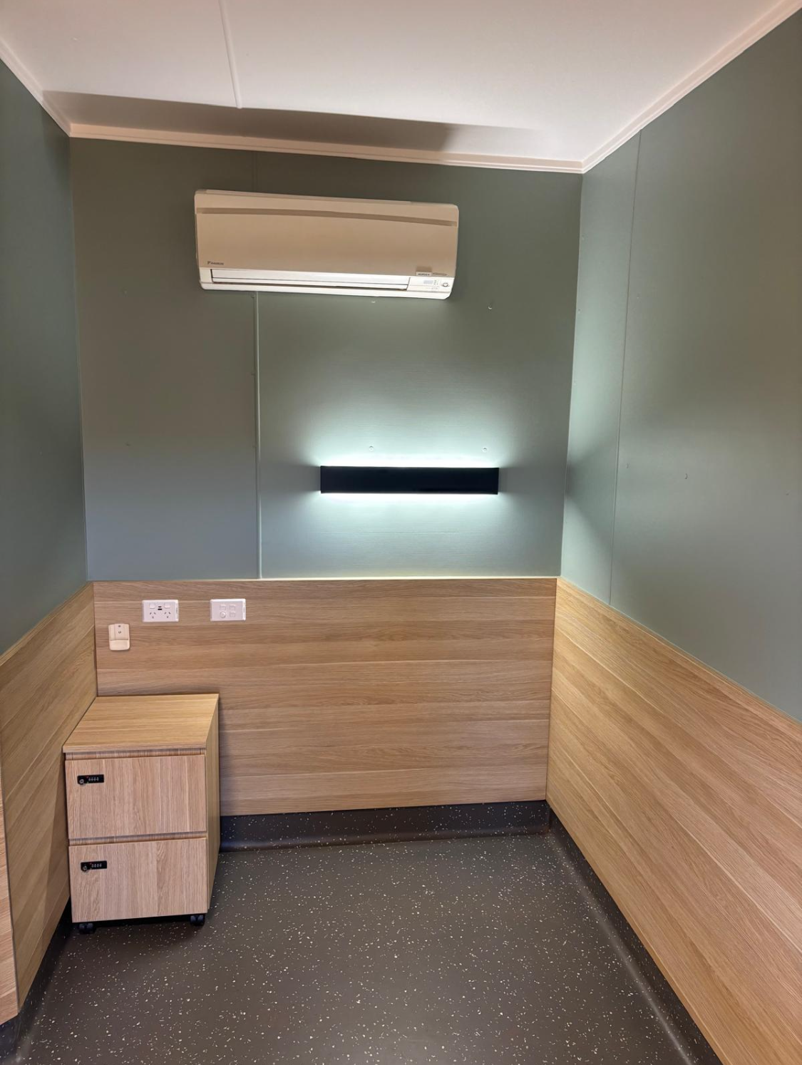 A workspace with a desk and air conditioning unit, showcasing HVAC services designed for the mining industry