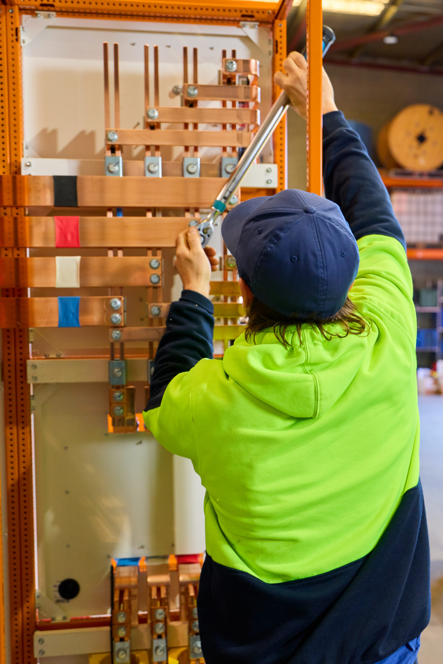 Worker fixing a panel on-site with skilled support from Progrid labour hire services ensuring efficiency and safety